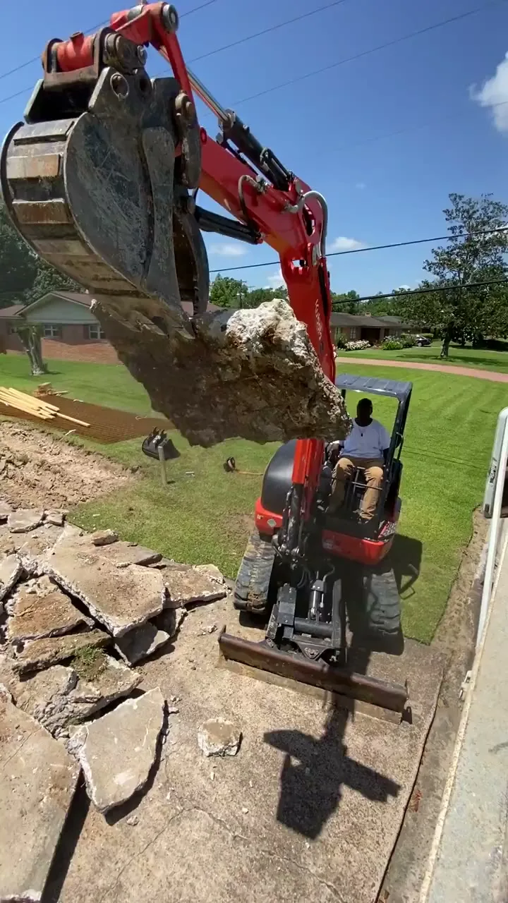 Excavator tearing out a concrete slab for haul-off in Beaumont TX
